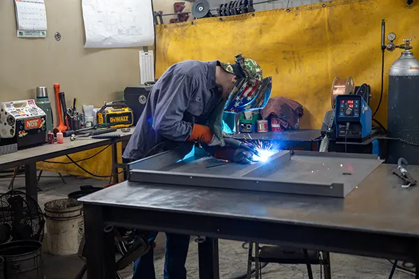 a person welding at Kinninger Custom Fabrication